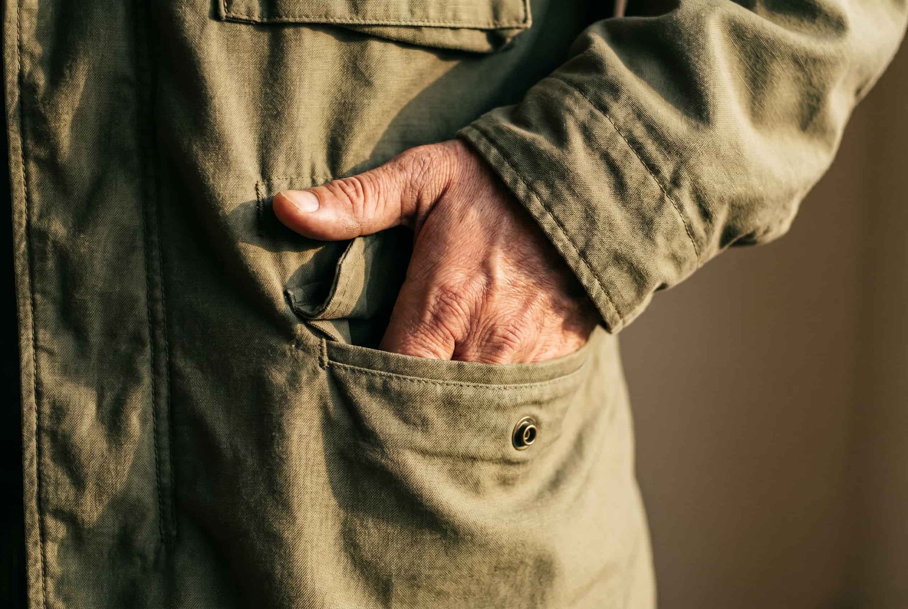 DETAIL 03 — worn-in pocket, hand entering · lived-in